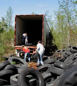 youth loading scrap tires into truck